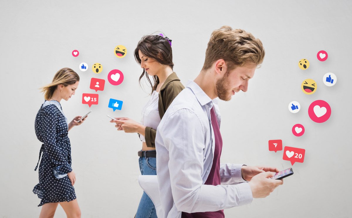 Person managing multiple social media platforms on a phone